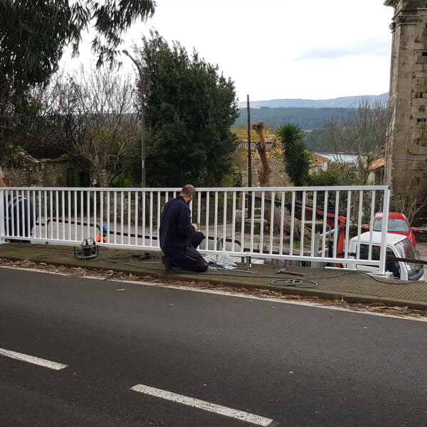 Operario instalando de barandillas en carreteras